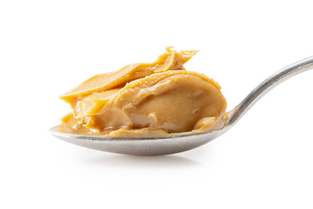 istock peanut butter in spoon isolated on white background 1223137234