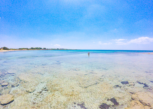 Wonderful sandy beach with transparent crystal clear water in summer in Salento, Puglia, Italy
