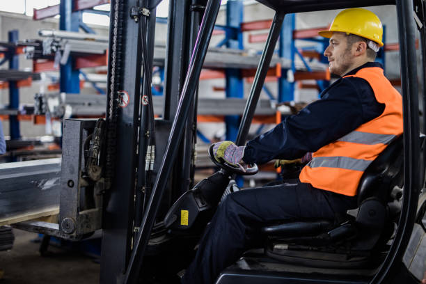 istock Mid adult manual worker in a forklift at warehouse. 1223138398