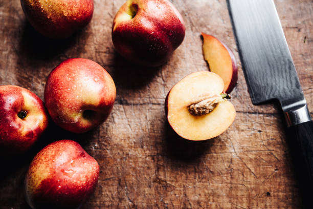 istock Nektarines on a cutting wood table and knife 1223138414