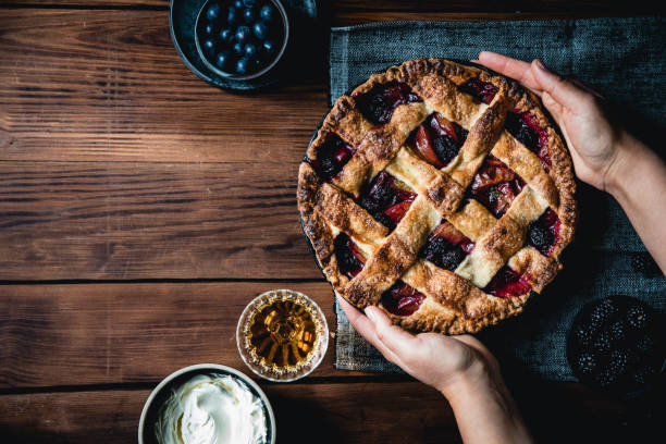 Woman holding a typical german lattice fruit pie