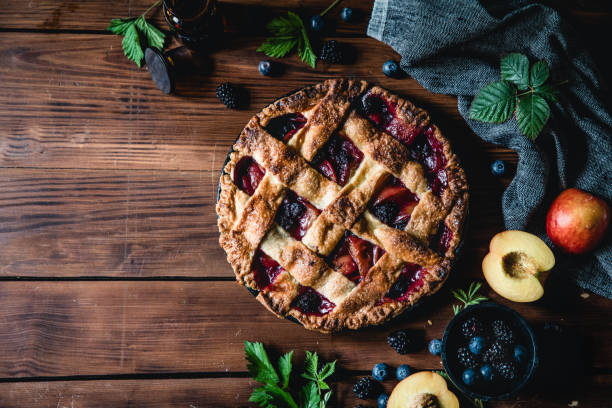 High angle photograph of a lattice fruit pie Lattice fruit pie freshly baked lying on a wooden table sweet pie photos stock pictures, royalty-free photos & images