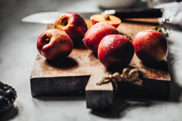 istock Wooden cutting board with healthy nectarine fruit 1223139347