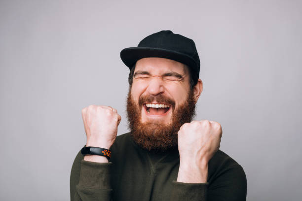 istock Happy bearded man is screaming yes while making he winner gesture with both hands. 1223139478