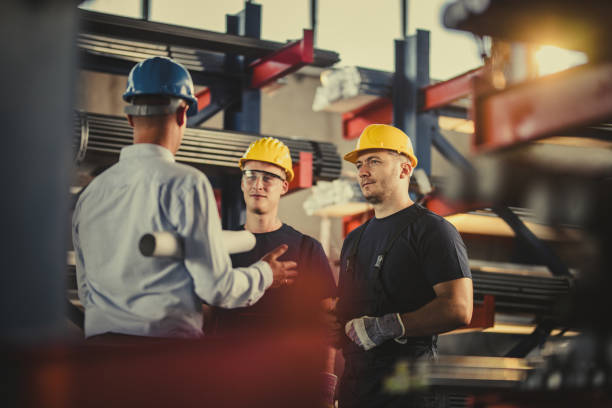 istock Manual workers talking to quality control inspector in aluminum mill. 1223139660