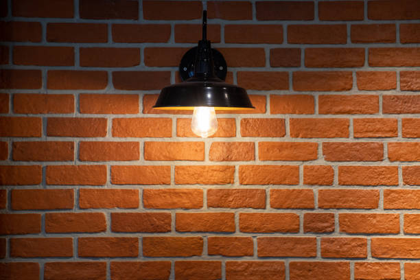 istock black steel vintage lamp wall on red brick background. 1223139714