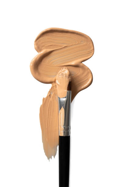 istock Beige liquid creamy foundation stroke smear and make-up brush isolated on white background, top view. BB cream or CC cream sample smudge, vertical 1223140652
