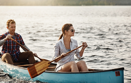 Shot of a young couple going for a canoe ride on the lake