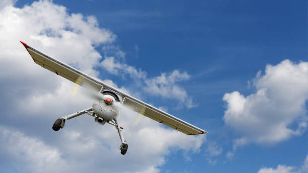 istock Light propeller-driven airplane flies against a background of cloudy blue sky. Copyspace. 1223142028