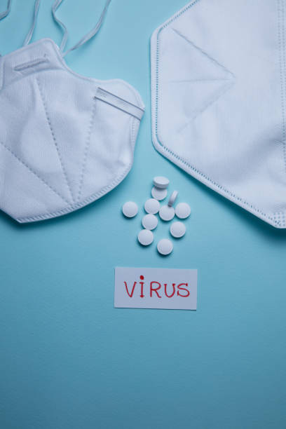 istock pills and protective mask on a blue background 1223143384