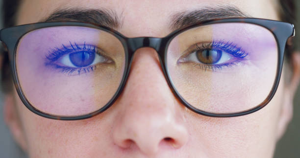 Close up of young businesswoman with brown eyes wearing the glasses looking on the waveform lines expressed Close up of young businesswoman with brown eyes wearing the glasses looking on the waveform lines expressed concept of stock market,augmented reality, technology, stock exchange  and finance environment computer cloud leadership stock pictures, royalty-free photos & images