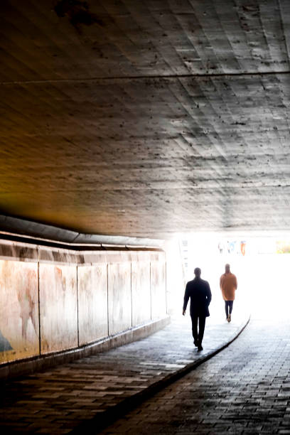 Stockholm, Sweden May 5, 2020 Two men walking in an underground tunnel,