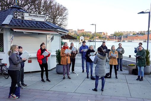 Stockholm, Sweden May 5, 2020 Choir singers practicing outdoors near City Hall as churches are closed during the Covid-19 epidemic.