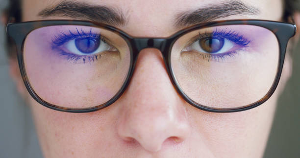 Close up of young businesswoman with brown eyes wearing the glasses looking on the waveform lines expressed Close up of young businesswoman with brown eyes wearing the glasses looking on the waveform lines expressed concept of stock market,augmented reality, technology, stock exchange  and finance environment computer cloud leadership stock pictures, royalty-free photos & images