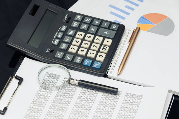 istock Business financial documents, office calculator and pen on the table. Numbers and graphs. 1223148438