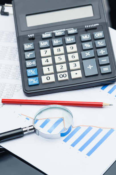istock Business financial documents, office calculator and pen on the table. Numbers and graphs. 1223148514
