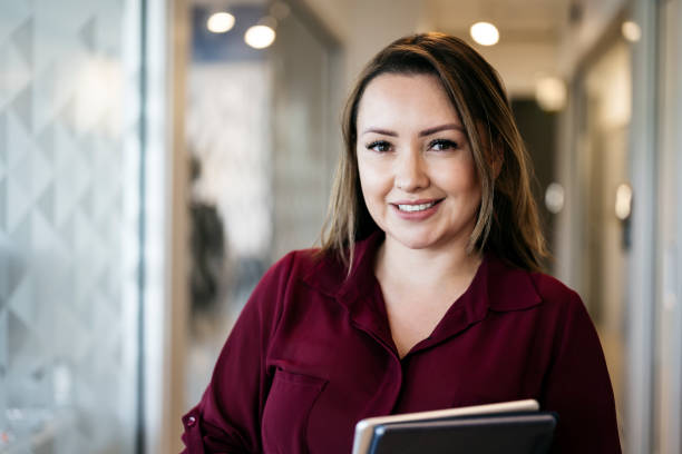 Smiling Hispanic woman in mid 30s at work
