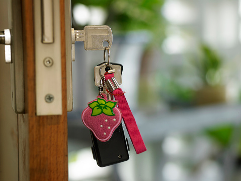 door key with decorative strawberry key ring with copy space