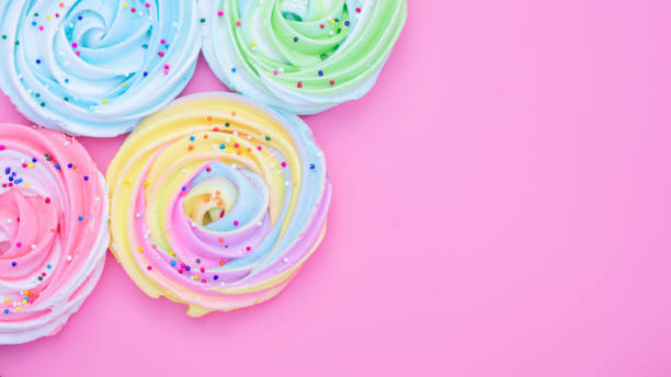 istock Colorful meringue lollipop on a pink background. 1223156473