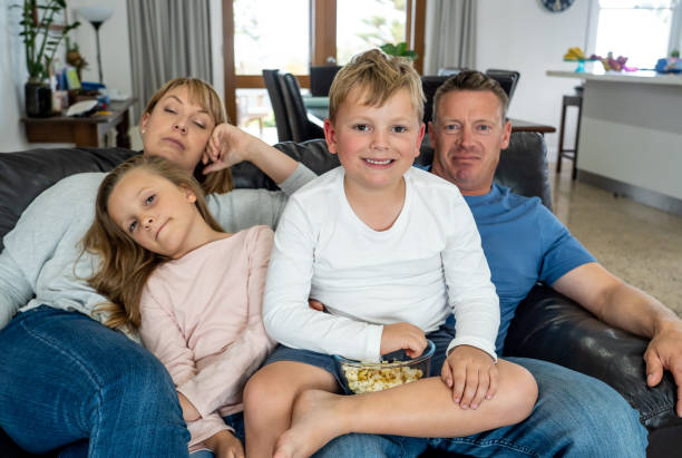 istock Coronavirus lockdow. Bored family watching tv helpless in isolation at home during quarantine COVID 19 Outbreak. Coronavirus lockdown and social distancing impact in mental health concept. 1223157692
