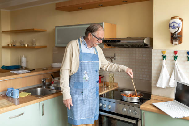 istock Senior Couple is Preparing Delicious Dinner in the Kitchen. 1223160791
