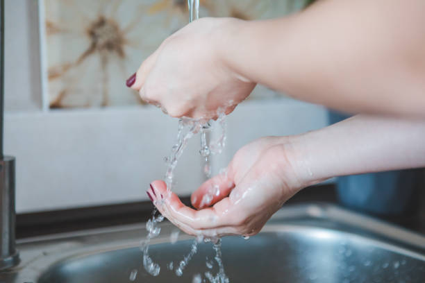 istock washing woman hands in bathroom 1223160850