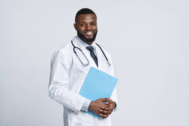 istock Cheerful black therapist holding medical chart over white 1223161523