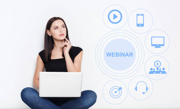 istock Thoughtful young girl using laptop for remote learning, word WEBINAR and educational icons on screen, collage 1223161744