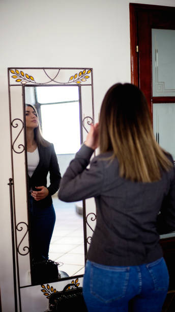 istock Young beautiful woman looking her reflection in mirror 1223161757