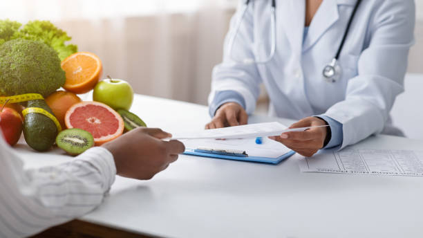 istock Cropped of doctor and patient hands holding document 1223162610