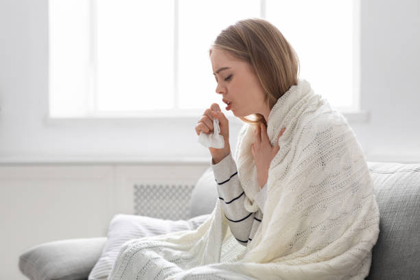 istock Sick young woman coughing at home, empty space 1223162977