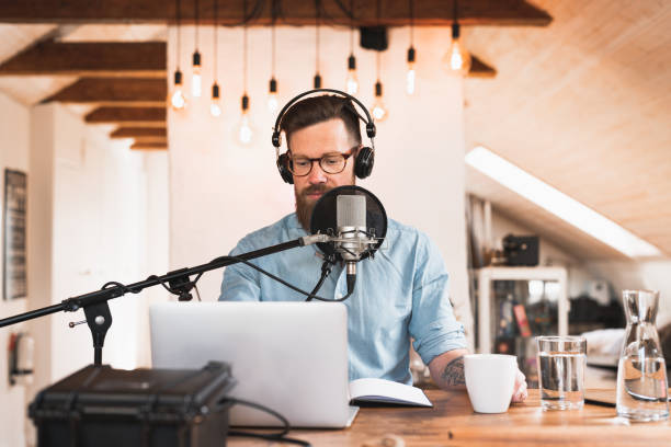 istock Man recording a podcast from home 1223166281