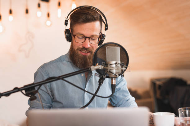 istock Man recording a podcast from home 1223166306