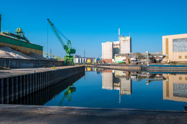 Mortar and cement industry with large crane along the water of the river Rhine in the town of Wageningen, Netherlands.
