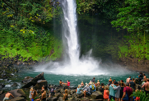 La Fortuna, Costa Rica - January 16, 2020 : Tourists and locals visiting the La Fortuna waterfall. This scenic waterfall is located in the rain forest of Tenorio volcano national park.