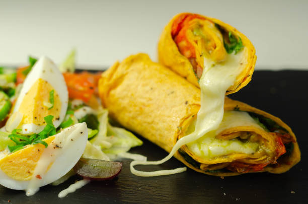 istock Tomato tortilla wrap with mozzarella cheese,  tomatoes, rocket, basil pesto,  and mix salad 1223169036