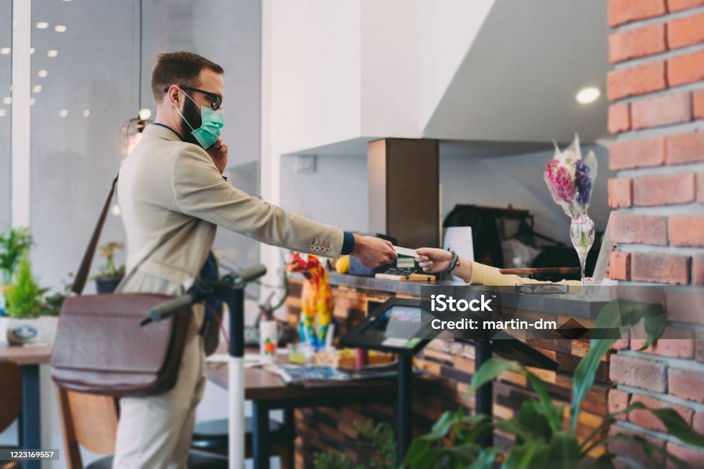 Business travel Receptionist giving card key to hotel guest after COVID-19 pandemic Hotel Stock Photo