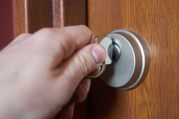 istock Caucasian's hand with key opening door 1223169902