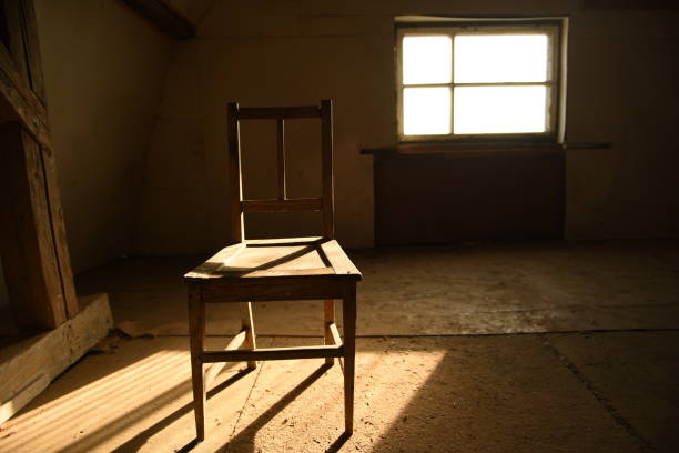 istock Old wooden chair in an empty room. 1223170992