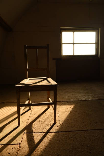 istock Old wooden chair in an empty room. 1223171135