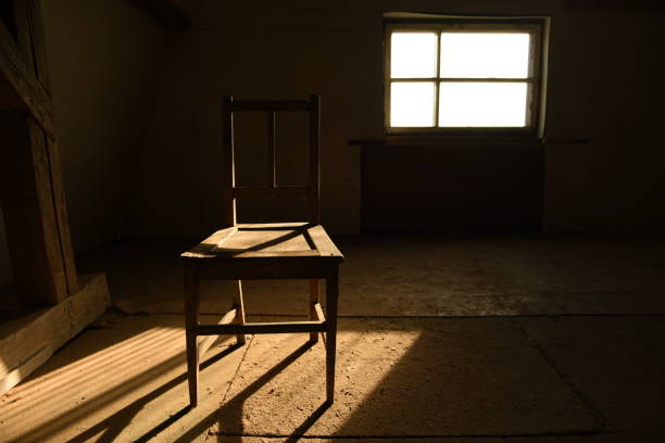 istock Old wooden chair in an empty room. 1223171288