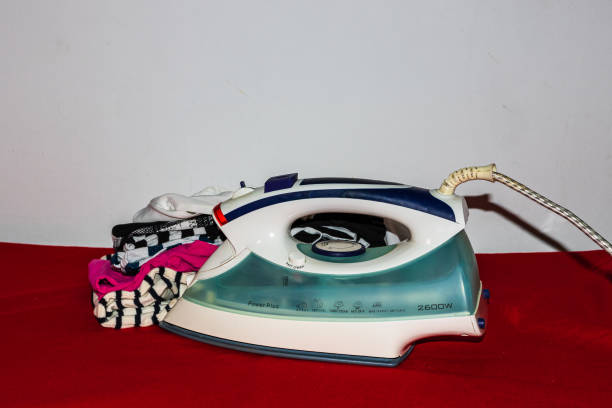istock Stack of colorful cotton clothes and iron. Household laundry ironing isolated. 1223172412