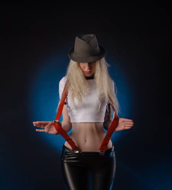istock bright blonde in a hat against a dark background 1223173908