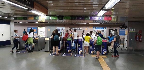 Looking At Advertisement Sign, People Standing, Checking In With Brazilian Public Transportation Card At Access Gate Of Rio De Janeiro Metro Station In Brazil