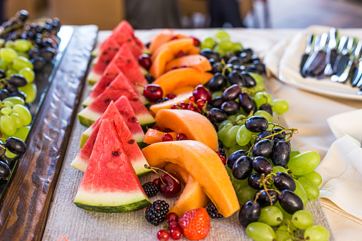 mixed sliced fruits with watermelon, melon, strawberry and grapes, on plate