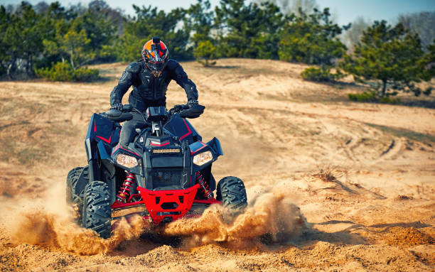 Racing in the sand on a four-wheel drive quad.