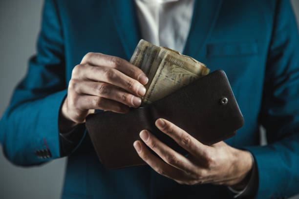 istock business man hand money with wallet 1223179119