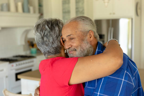 istock Happy senior couple hugging each other in their kitchen 1223180503