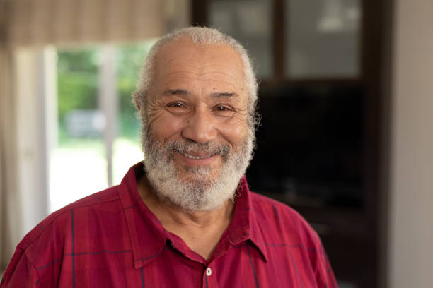 istock Senior man smiling at camera at home 1223180957