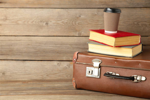 istock Old suitcase and books with cup of coffee 1223182642